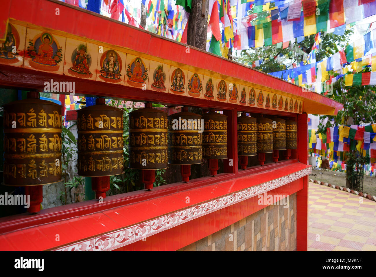 Prayer wheels and flags  at entrance to Mahakal Temple on Observatory Hill, Darjeeling, West-Bengal, India Stock Photo