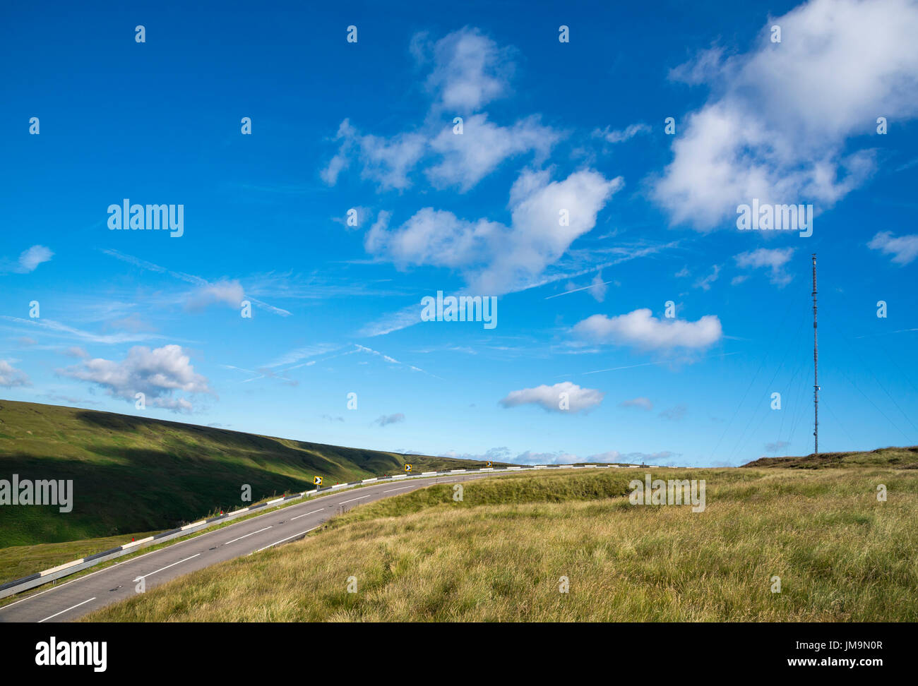 The A6024 Woodhead road over the Pennines on the border of Derbyshire and West Yorkshire. Holme Moss radio mast on Black Hill. Stock Photo