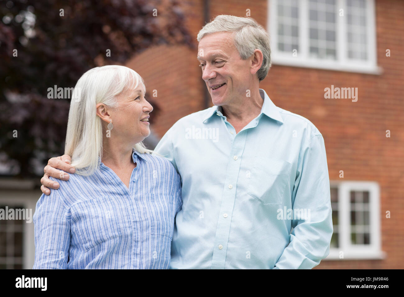 Retired Couple Standing Outside Home Stock Photo - Alamy