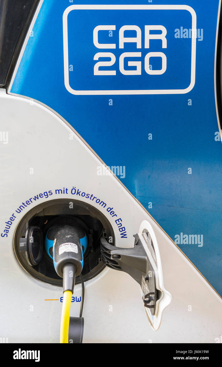 electric shared car vehicle of car2go fleet being charged at a charging station operated by energy supplier EnBW, stuttgart, baden-wuerttemberg, germa Stock Photo