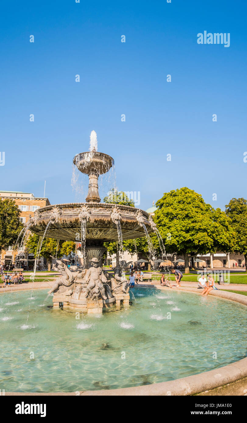 people relaxing at the fountain in the gardens of new palace, neues schloss, stuttgart, baden-wuerttemberg, germany Stock Photo