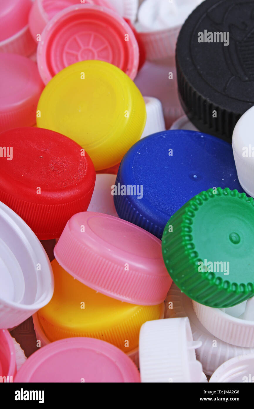 Collect plastic bottle caps. Closeup shot of stack of recyclable plastic bottle caps on white