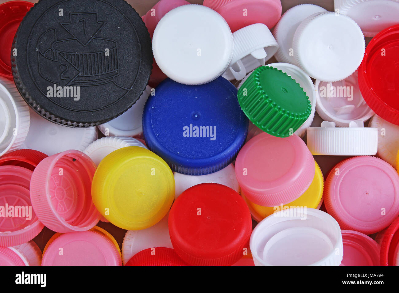 Collect plastic bottle caps. Closeup shot of stack of recyclable