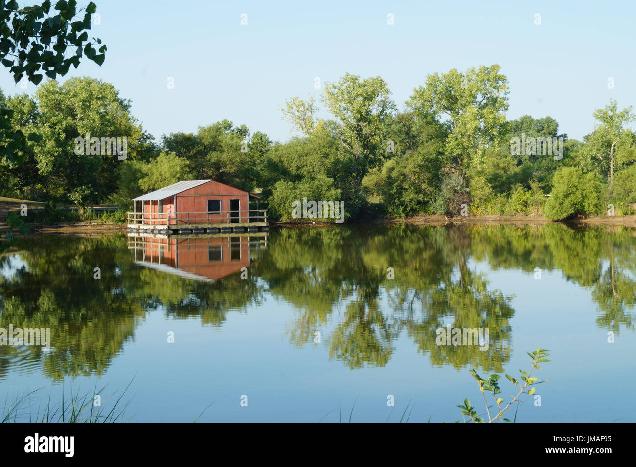 A red fishing shack on a calm lake Wichita Kansas USA Stock Photo