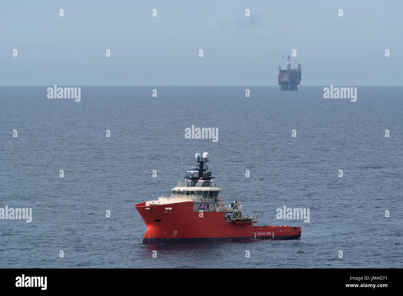 Offshore vessel providing standby cover to an oil and gas rig in the north sea. credit: LEE RAMSDEN / ALAMY Stock Photo