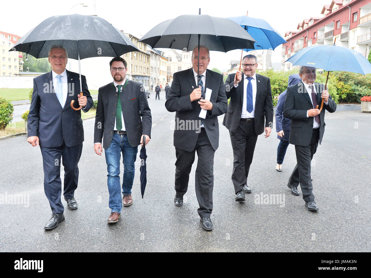 Nyrsko, Czech Republic. 26th July, 2017. Nyrsko mayor Miroslav Rubas, right, welcomes Czech Minister of Transport Dan Tok, second from right, Bavaria's Interior Minister Joachim Herrmann, left, and Franz Loffler, centre, of Provincial council of Cham district during celebrations of anniversary of CR-Bavaria bus line launch, the cross-border bus line project, in Nyrsko, Czech Republic, on Wednesday, July 26, 2017. Credit: Miroslav Chaloupka/CTK Photo/Alamy Live News Stock Photo