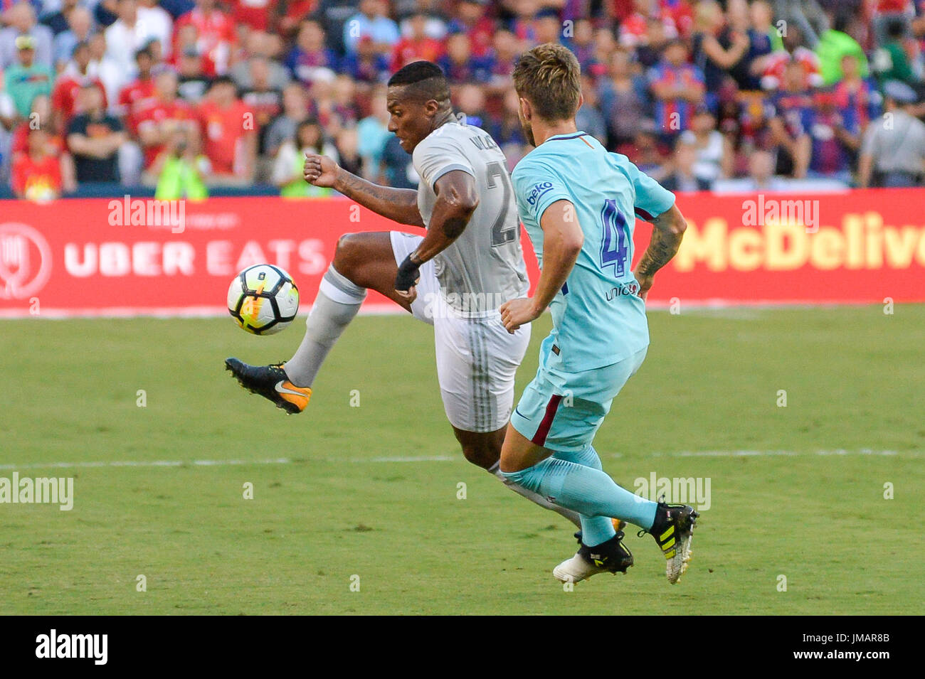 Landover, Maryland, USA. 26th July, 2017. Manchester United's ANTONIO VALENCIA (25) kicks the ball away from Barcelona Midfielder IVAN RAKITIC (4) during the first half of the game held at FEDEXFIELD in Landover, Maryland. Credit: Amy Sanderson/ZUMA Wire/Alamy Live News Stock Photo