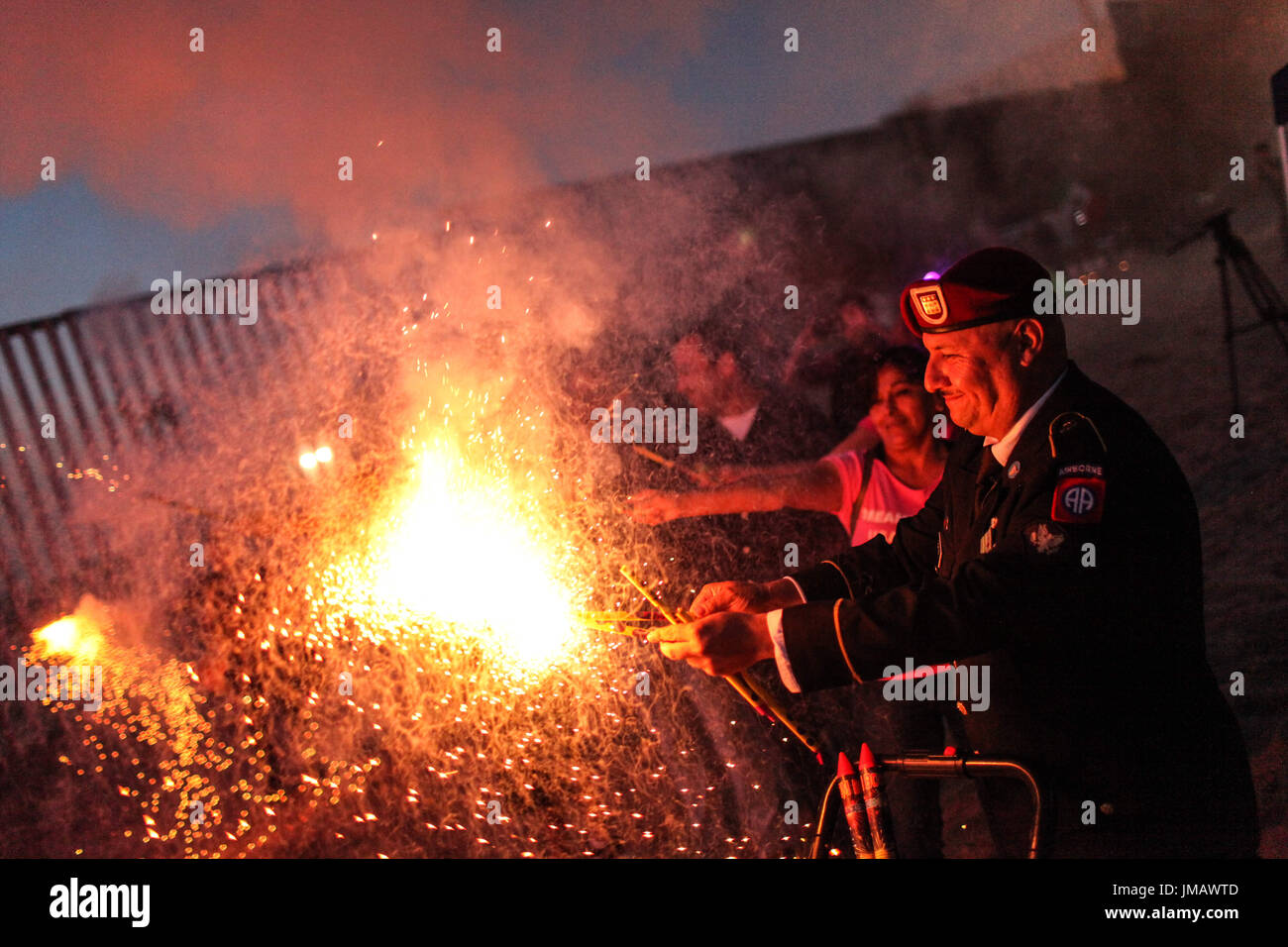 Tijuana, Baja California, Mexico. 4th July, 2017. HECTOR BARAJAS-VARELA, a deported U.S. Army veteran, lights fireworks during a 4th of July celebration along the US-Mexico border in Tijuana, Baja California, Mexico. Credit: Joel Angel Juarez/ZUMA Wire/Alamy Live News Stock Photo