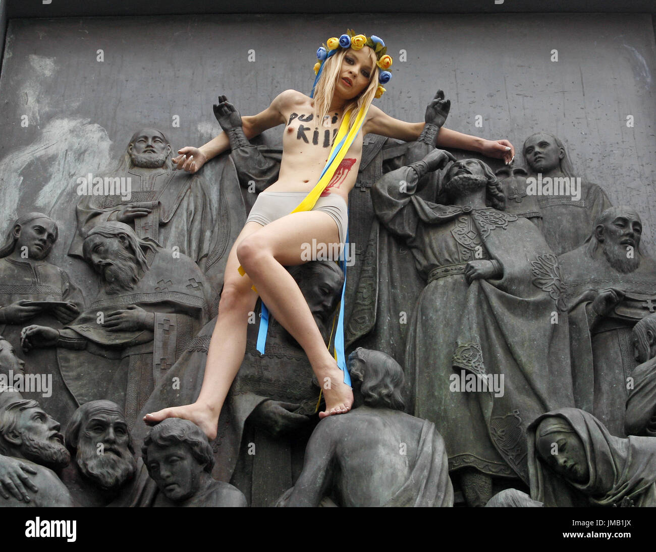 Kiev, Ukraine. 27th July, 2017. An activist of the women feminist movement 'FEMEN' protests on the monumetn of the St. Vladimir Statue, on St. Vladimir's Hill in center Kiev, Ukraine, on 27 July, 2017. FEMEN protest against a religion procession organized by the Ukrainian Orthodox Church of the Moscow Patriarchate in Ukraine, during celebration the 1029th anniversary of Kievan Rus Christianization in Kiev. Credit: Serg Glovny/ZUMA Wire/Alamy Live News Stock Photo