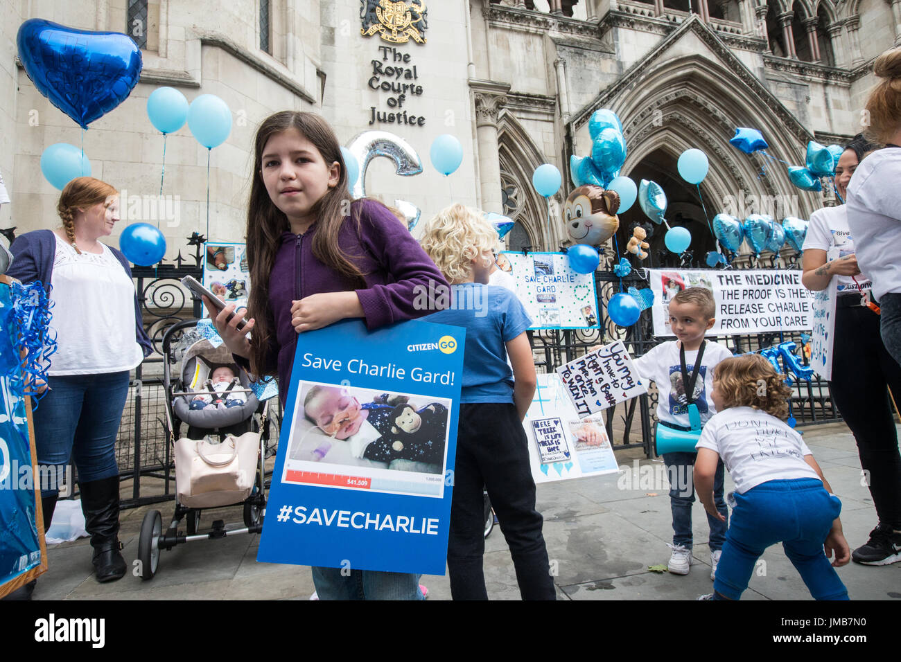 Supporters of the terminally-ill baby, Charlie Gard, demonstrate outside the High Court as Chris Gard and Connie Yates, say they are ending their case Stock Photo