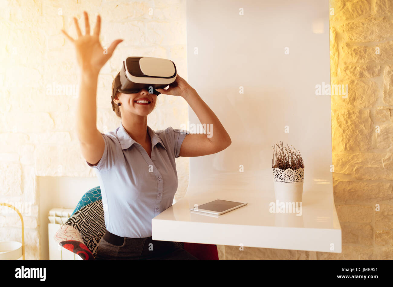 Smiling businesswoman using virtual reality glasses in a cafe Stock ...