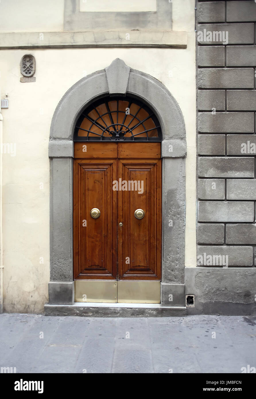 Fragment of old stone building with nice wooden door Stock Photo - Alamy