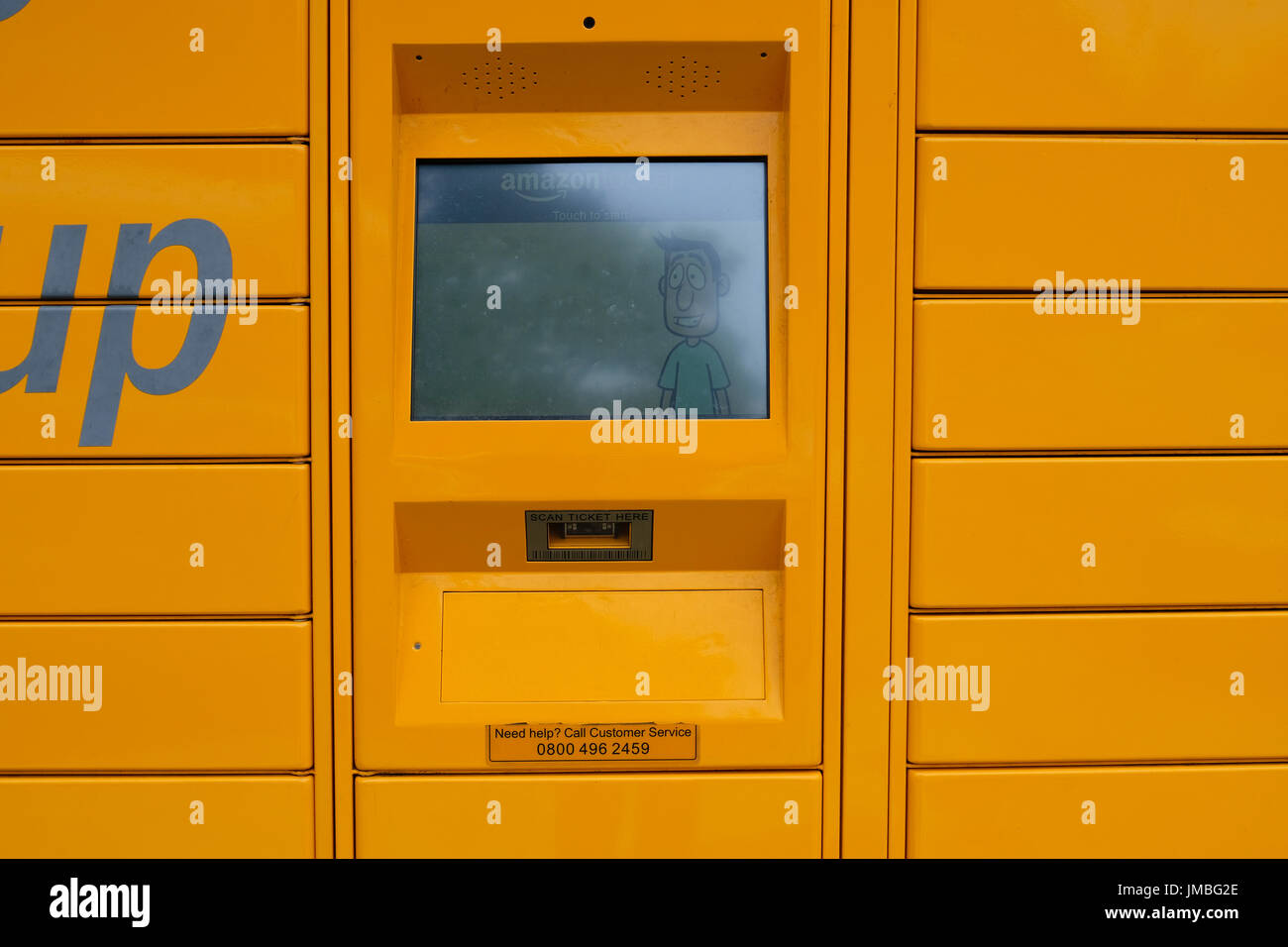 Bright yellow Amazon Locker called Binky situated in forecourt of service station. Worthing, UK Stock Photo