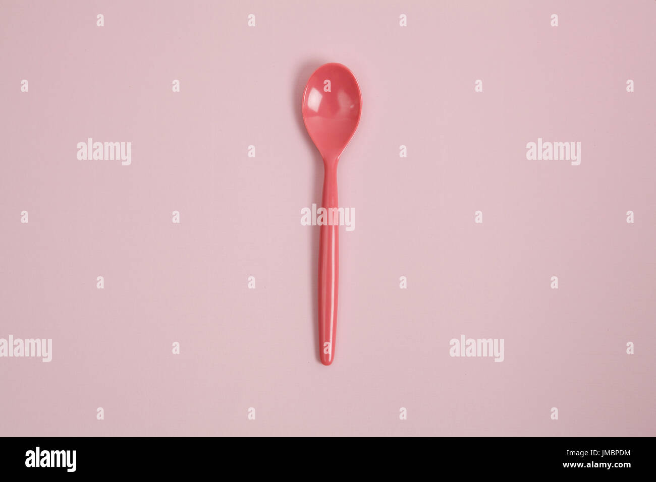 a pink spoon on a pink background. tone-on-tone photography and minimal ...