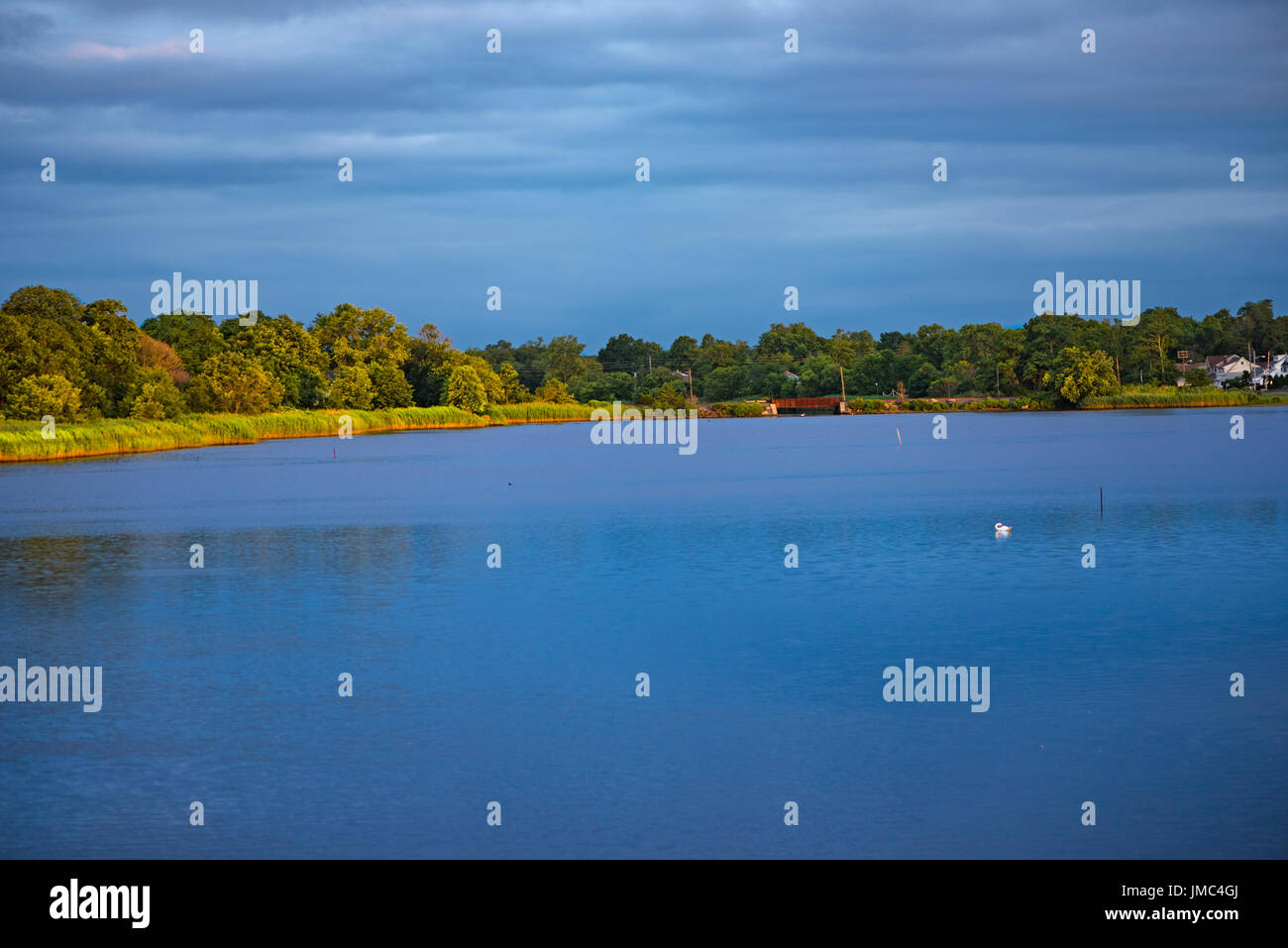 The still blue waters of Wreck Pond in Sea Girt shortly after daybreak