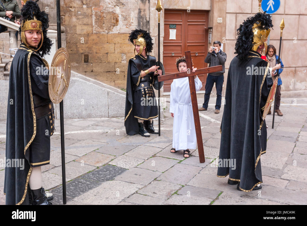 Little boy doing of Christ carrying a cross during Good Friday
