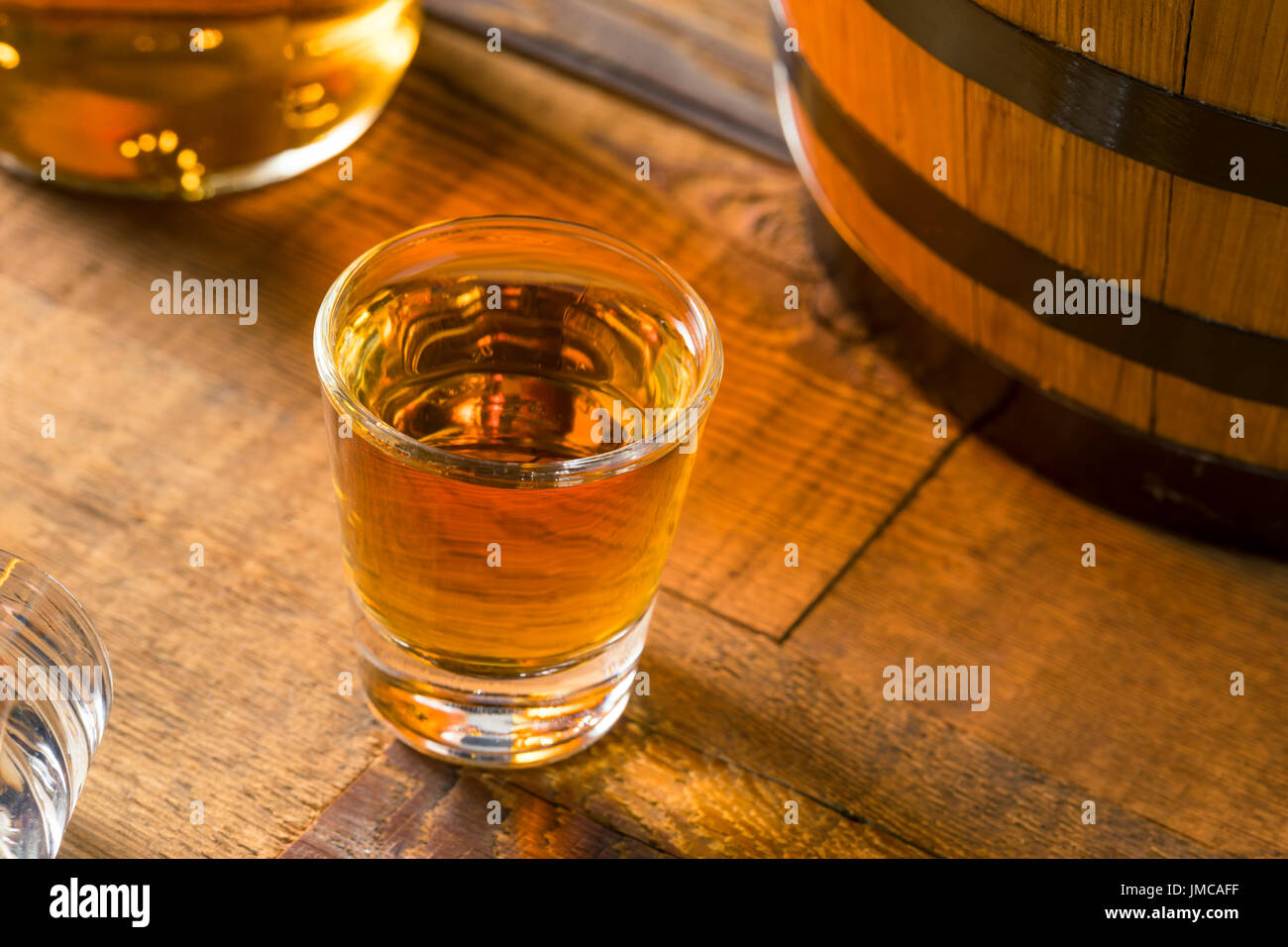 Alcoholic Brown Rum in a Shot Glass Ready to Drink Stock Photo