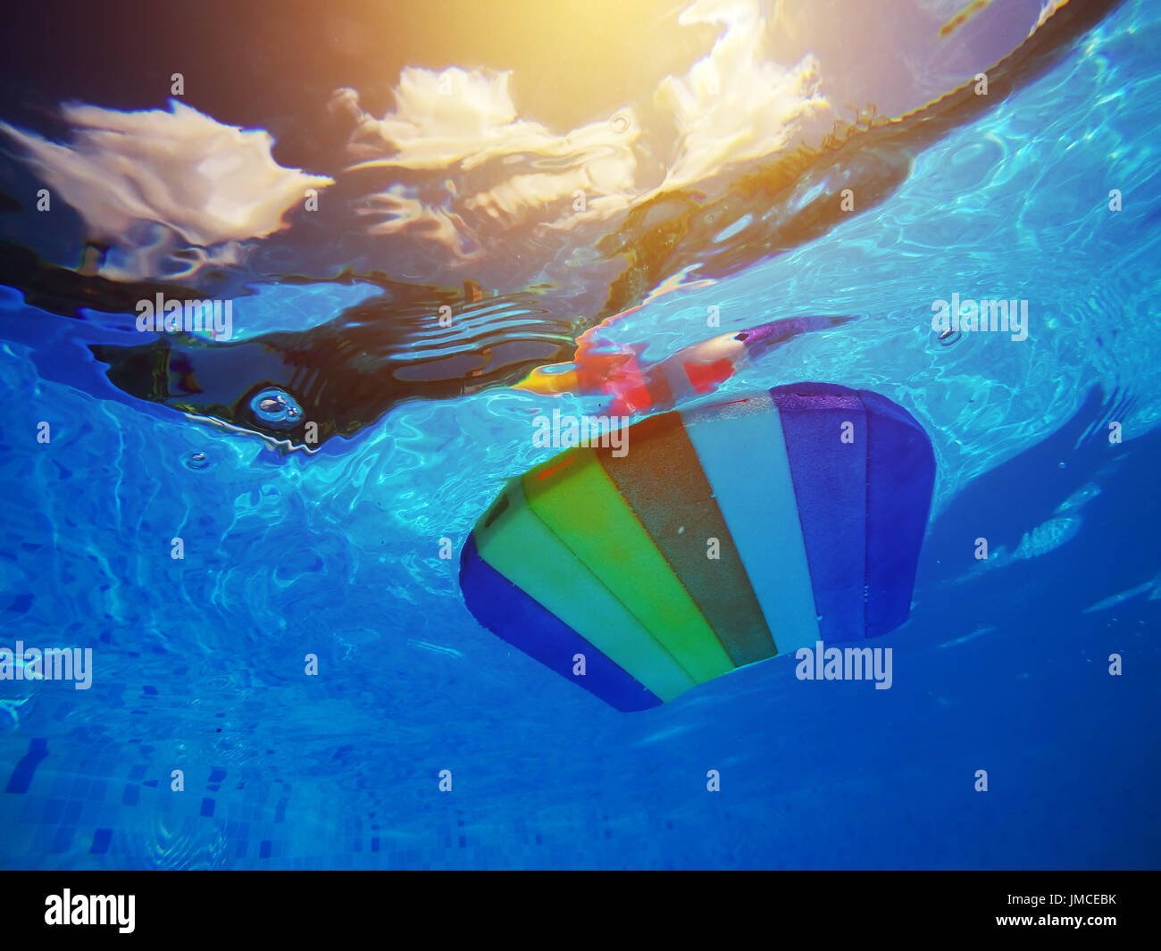 Rainbow pattern styrofoam swimming board or baseboard floating in