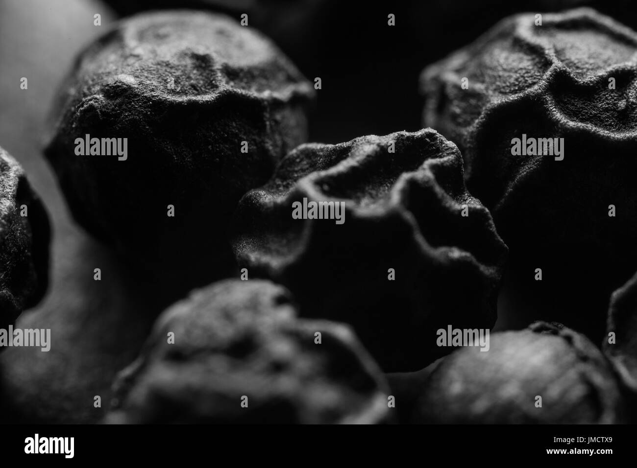 Macro photo of Peppercorns. Black and White Stock Photo