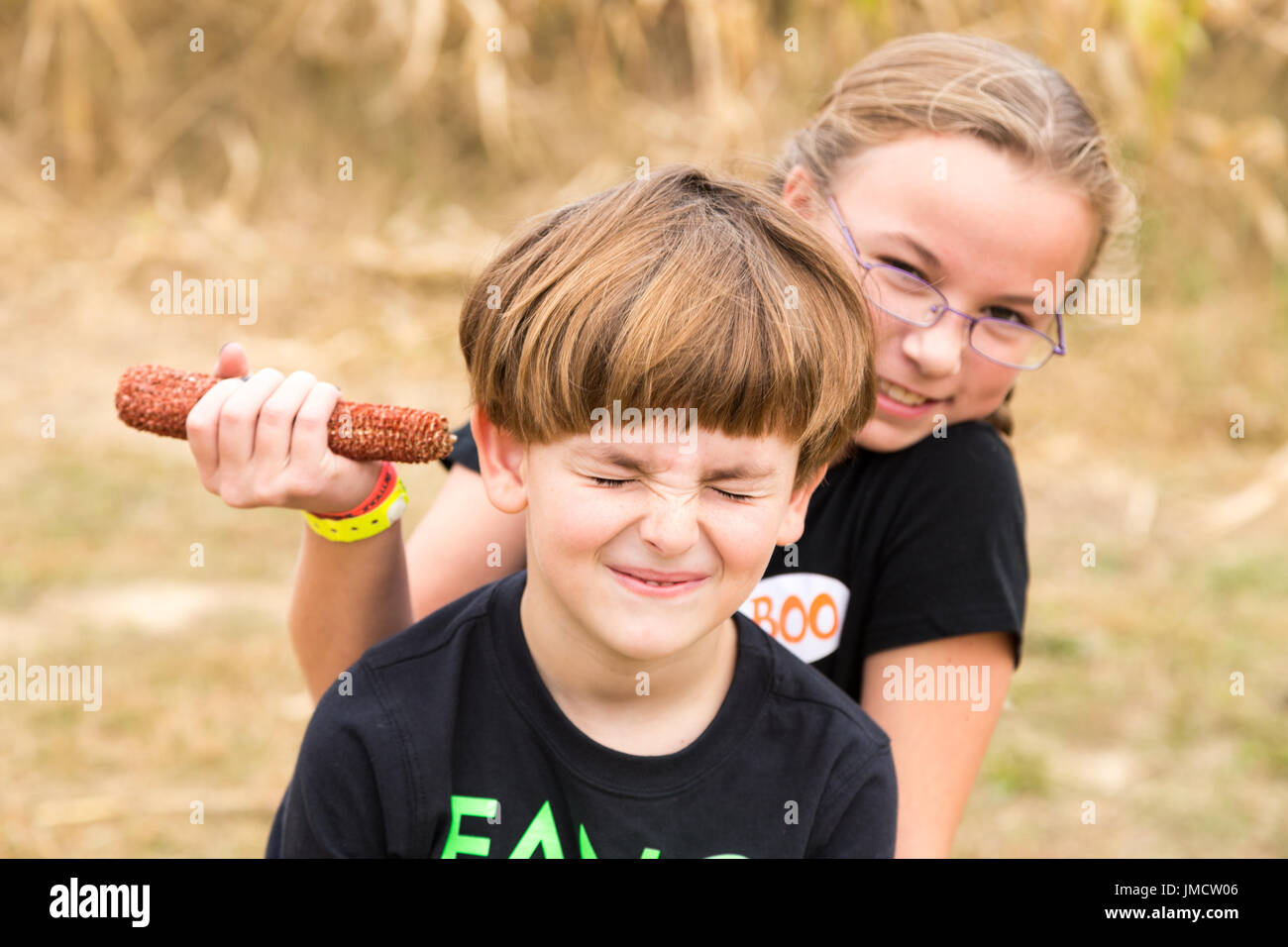 Sister playing prank on brother Stock Photo