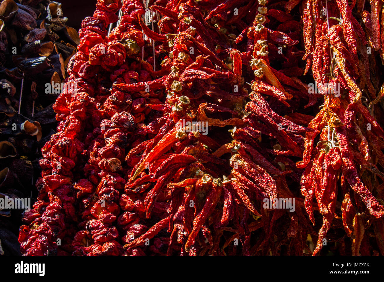 Bundles of red peppers dry in the sun Stock Photo - Alamy