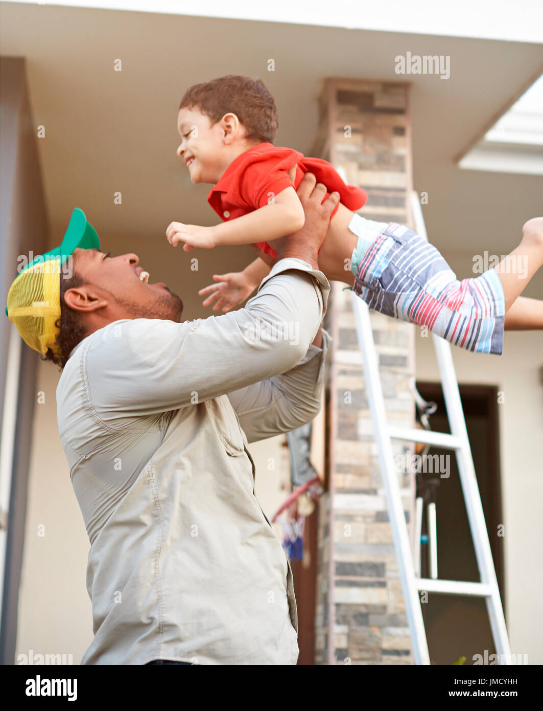 Happy hispanic family theme. Father throw in air after work. Father