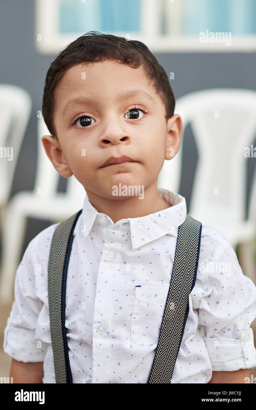 Portrait of hispanic boy in formal shirt. Close-up headshot of small latino boy Stock Photo