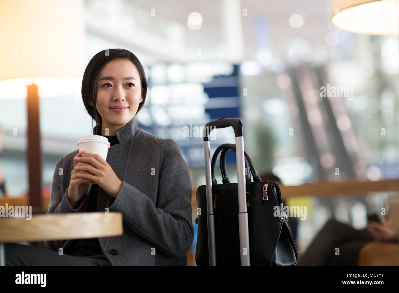 Chinese businesswoman waiting in airport Stock Photo