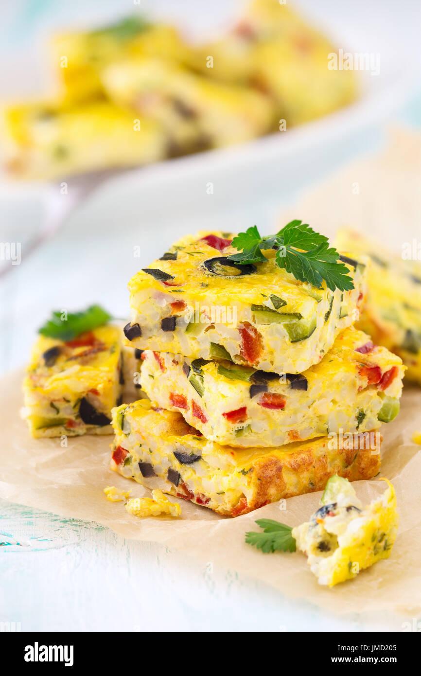 Homemade vegetarian rice frittata with zucchini, bell pepper and olives Stock Photo