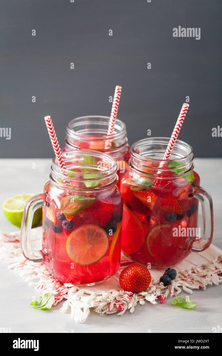 summer berry lemonade with lime and mint in mason jar Stock Photo