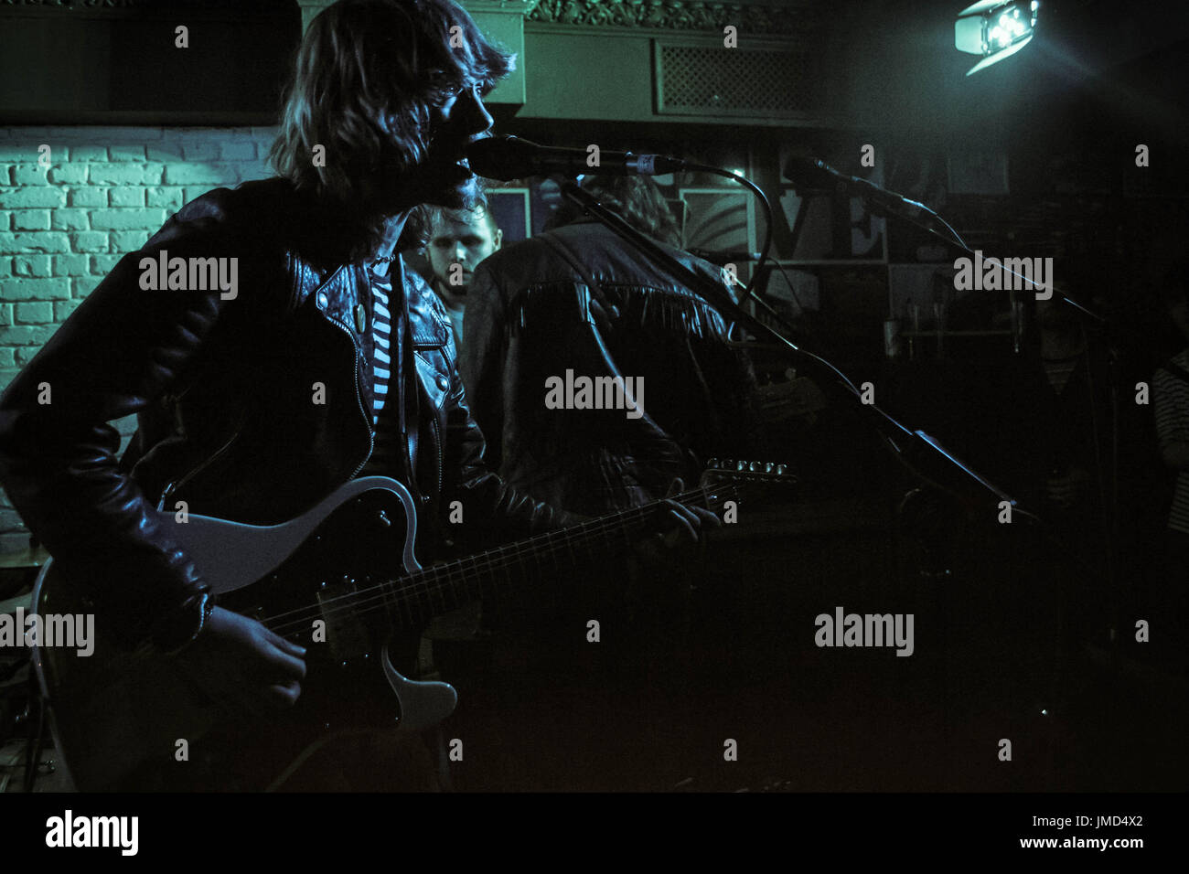 Rockstar singing into microphone Stock Photo