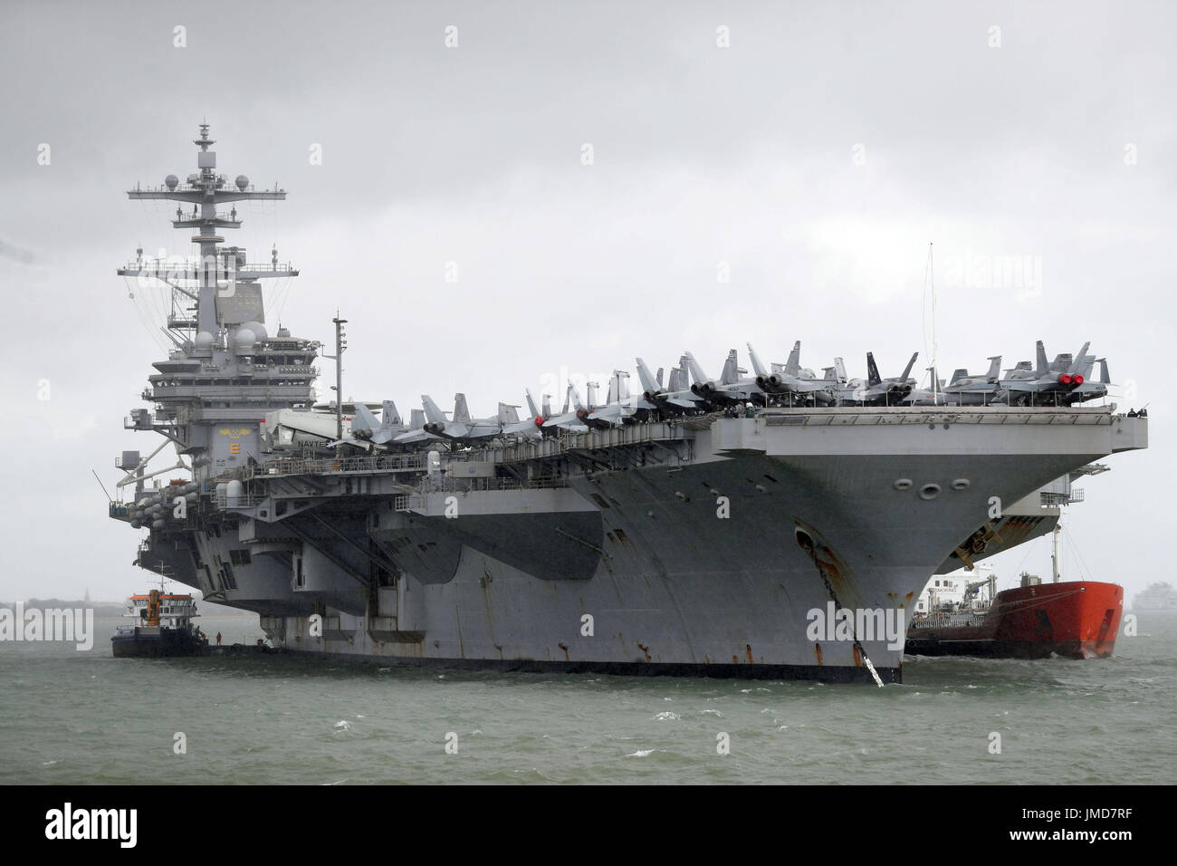 The US Navy Nimitz-class aircraft carrier USS George H.W. Bush as it lays at anchor off the coastbefore it participates n Exercise Saxon Warrior 2017 in the Northern Atlantic Ocean. Stock Photo