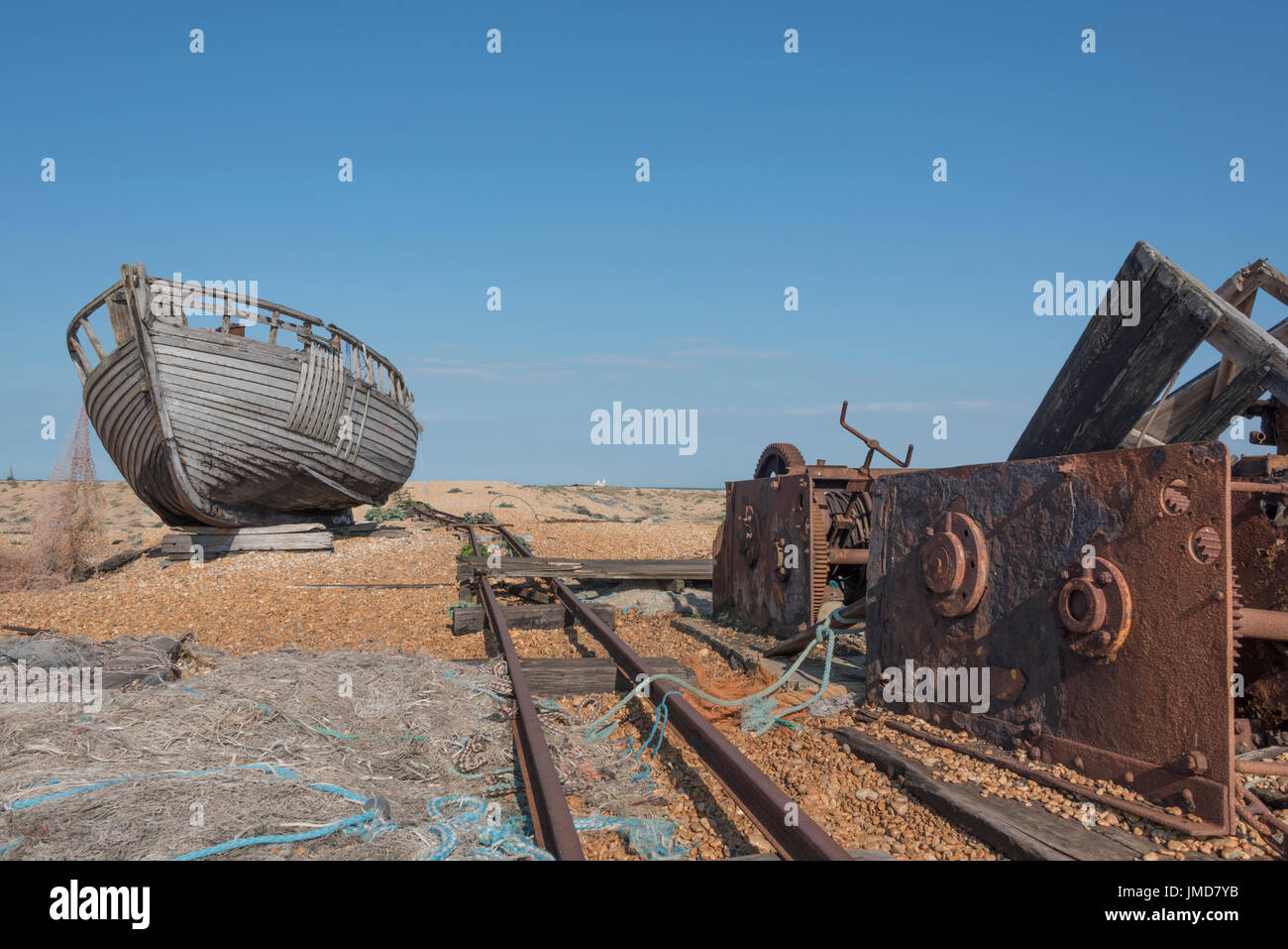 Old wooden fishing boat and a rusty winch on a beach Stock Photo - Alamy