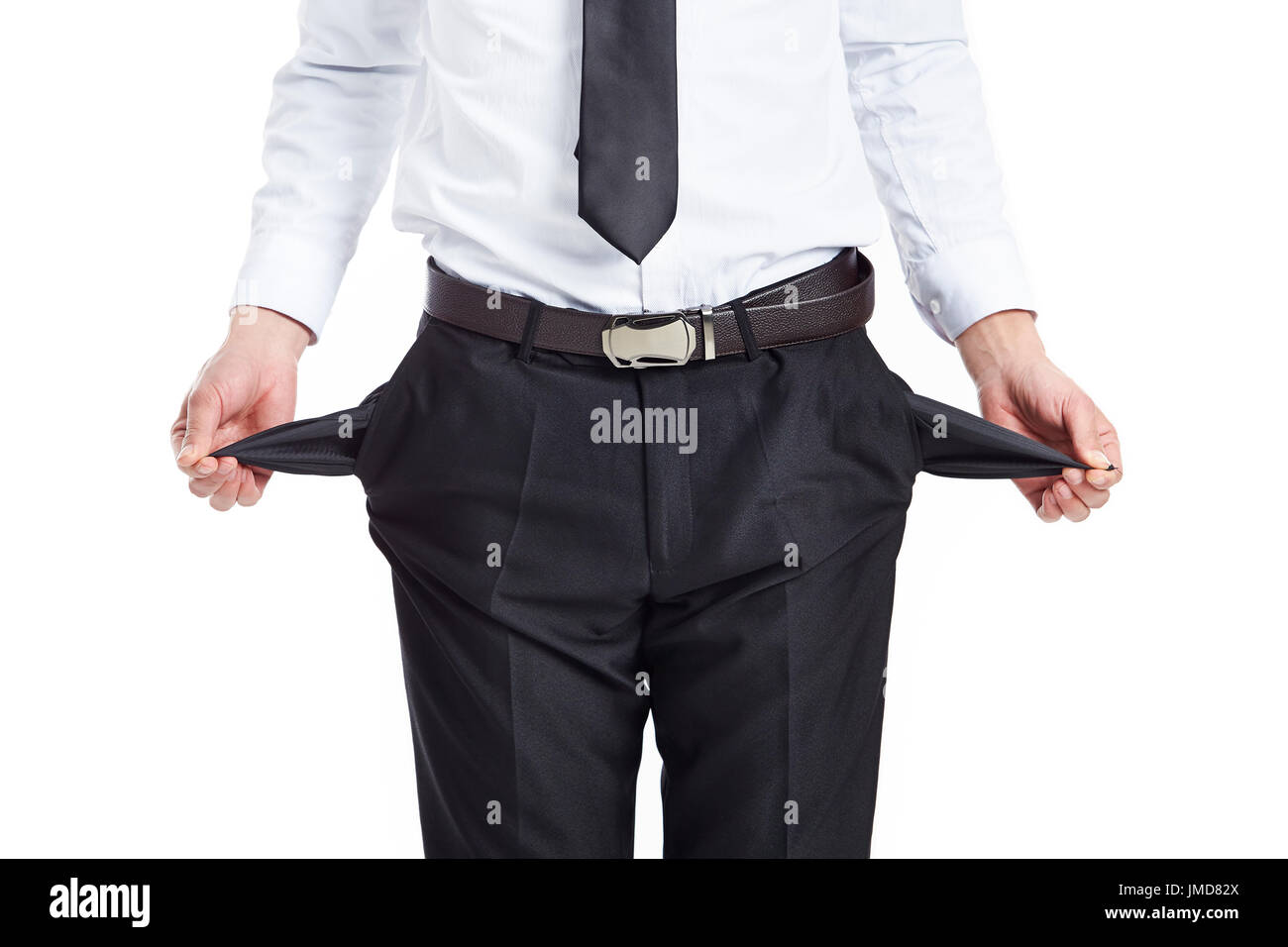 young businessman showing empty pockets, studio shot, isolated on white. Stock Photo