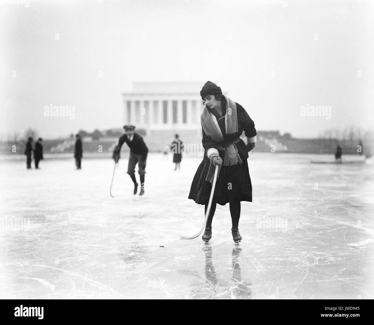 Woman Ice Skating with Hockey Stick with Lincoln Memorial in Background, Washington DC, USA, Harris & Ewing, January 1922 Stock Photo