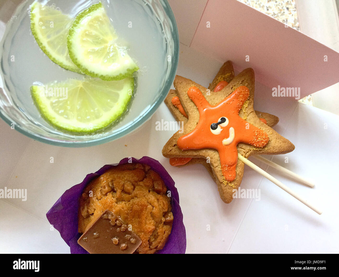 Ultimate good mood kit - Muffin, gin & tonic + ginger bread star Stock Photo