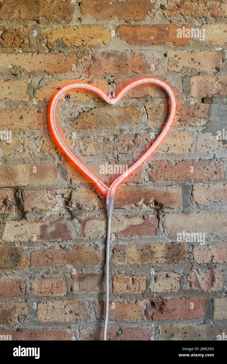 Heart shaped rope light on brick wall Stock Photo