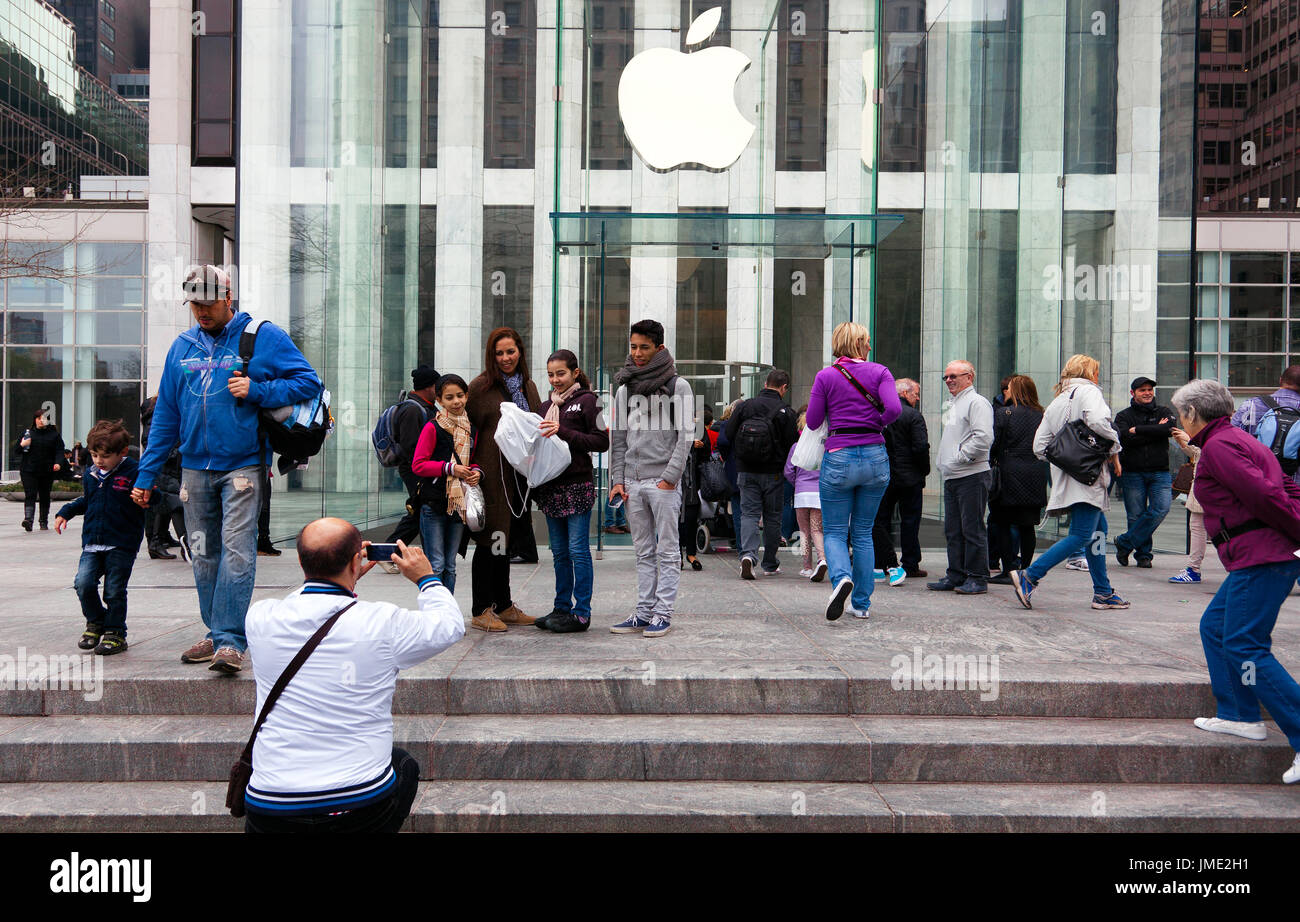 NEW YORK CITY - APRIL 1: Visitors take family pictures at Apple's flagship 5th Avenue store in New York City on April 1, 2012. Stock Photo