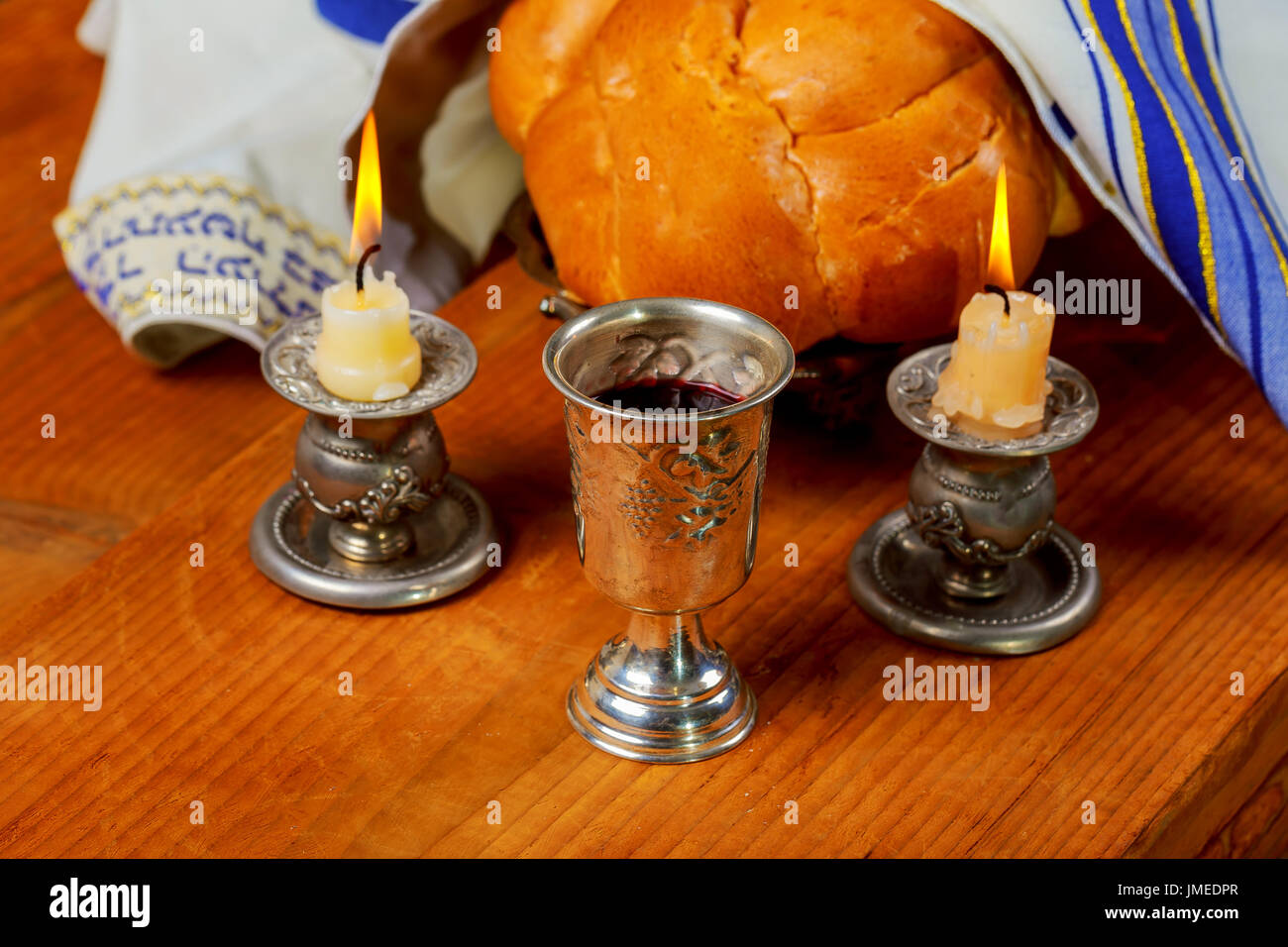 Sabbath image Silver kiddush cup, crystal candlesticks with lit