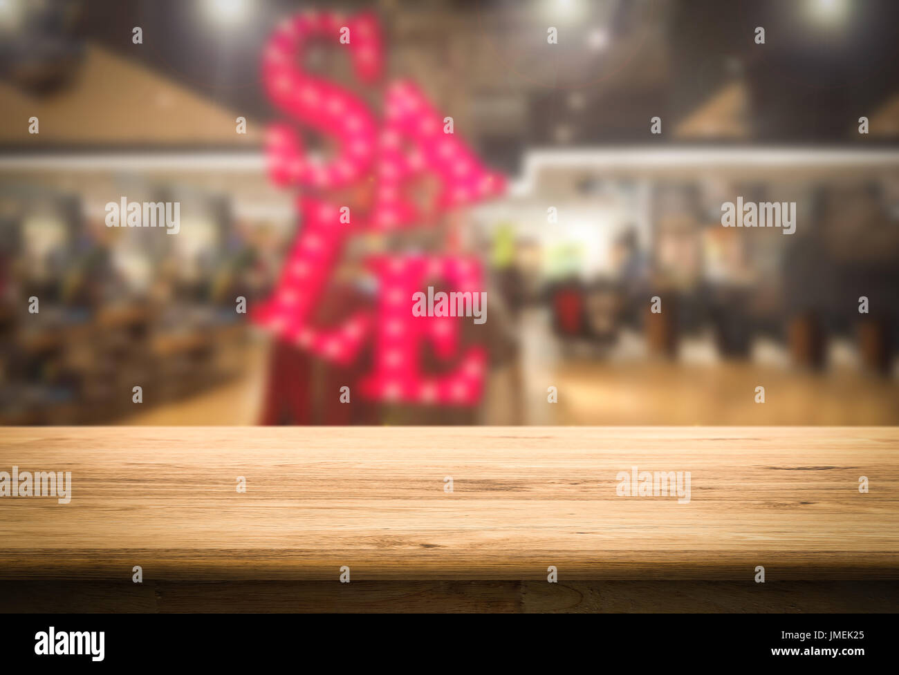 wooden counter with sale sign blurred background Stock Photo - Alamy