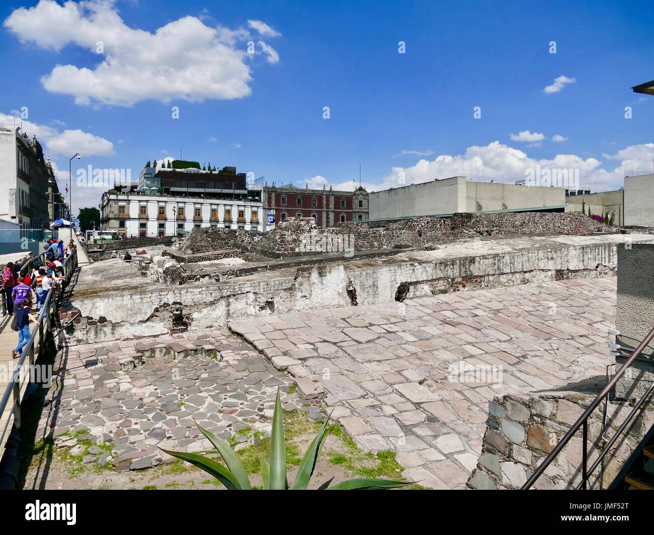 Visitors cross walkway over archeological excavation site of Aztec temple, near Zocolo Square, Central Mexico City, Mexico. Stock Photo