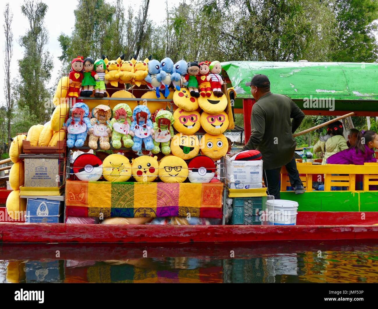 Boat vendor selling tourist items, dolls, pillows, Xochimilco, Mexico