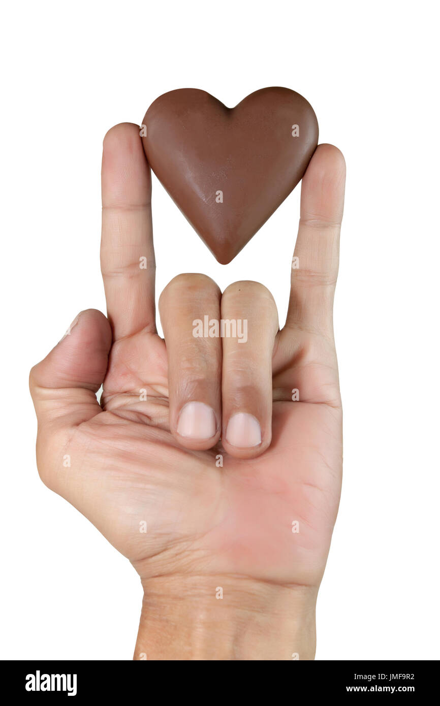male hand showing Sign language means that I Love you and chocolate heart shape. Isolated on white with work paths. Stock Photo