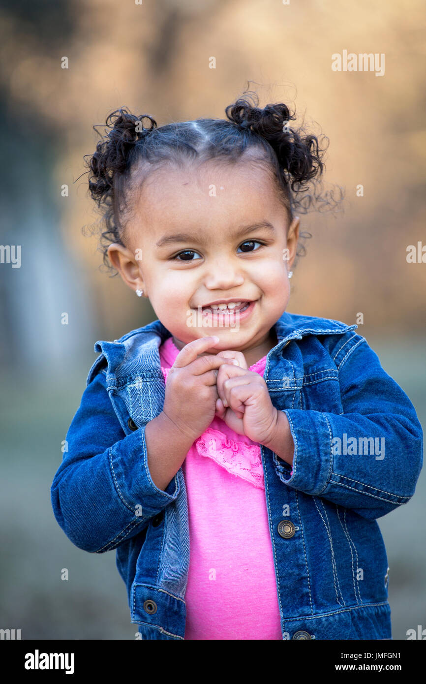 Happy mixed race little girl smiling. Stock Photo