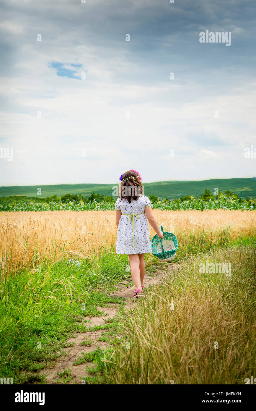 happy cute little girl in the wheat field Stock Photo - Alamy