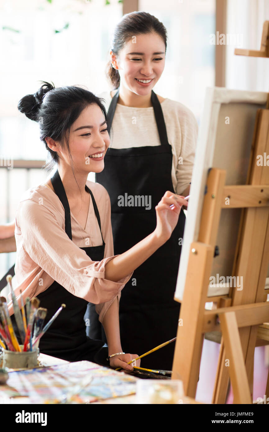 Young women painting in studio Stock Photo - Alamy
