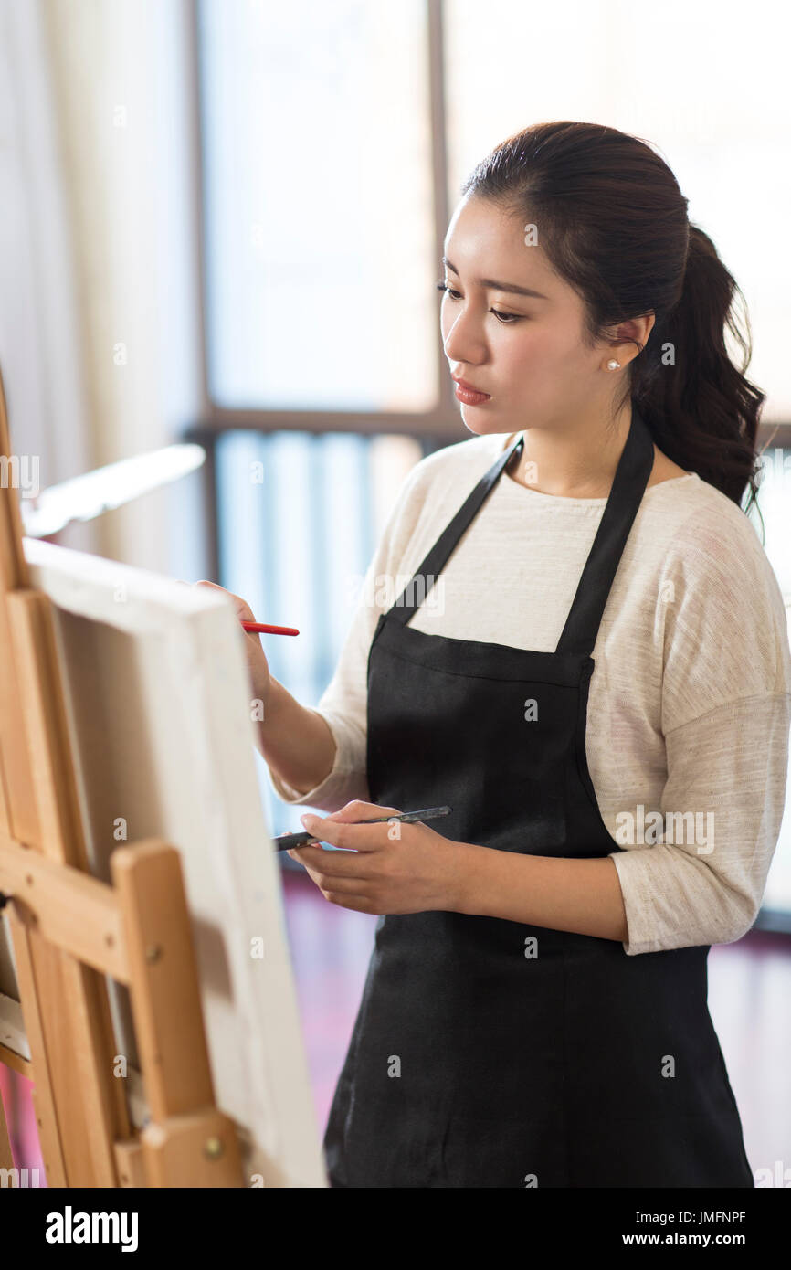 Female artist painting in studio Stock Photo - Alamy