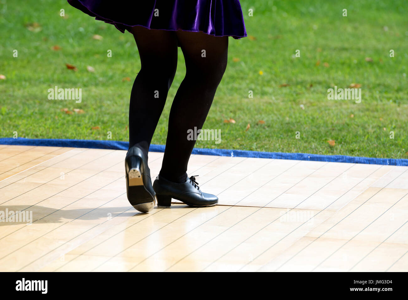 A girl performing traditional Irish dancing in public, UK Stock Photo