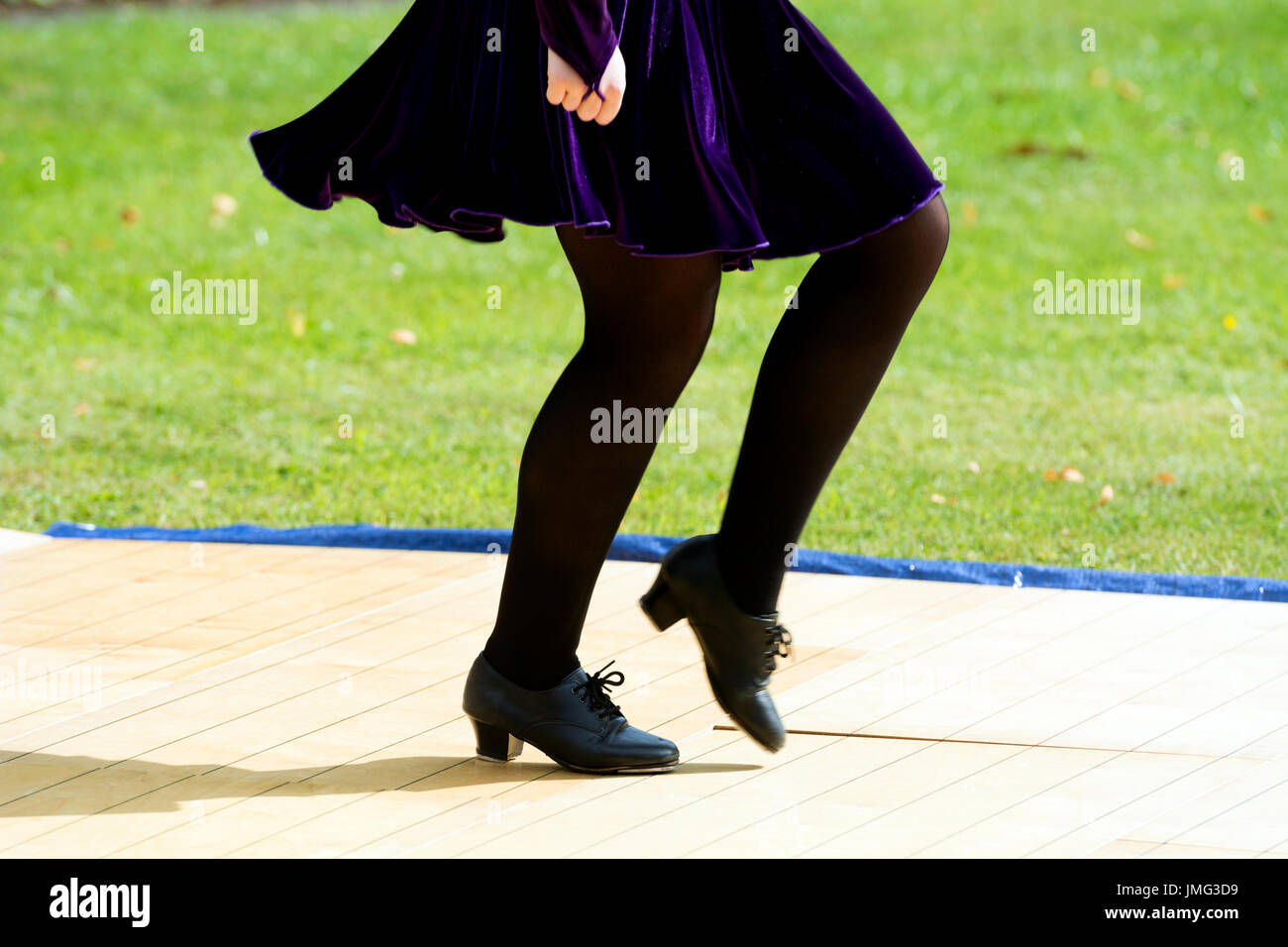 A girl performing traditional Irish dancing in public, UK Stock Photo