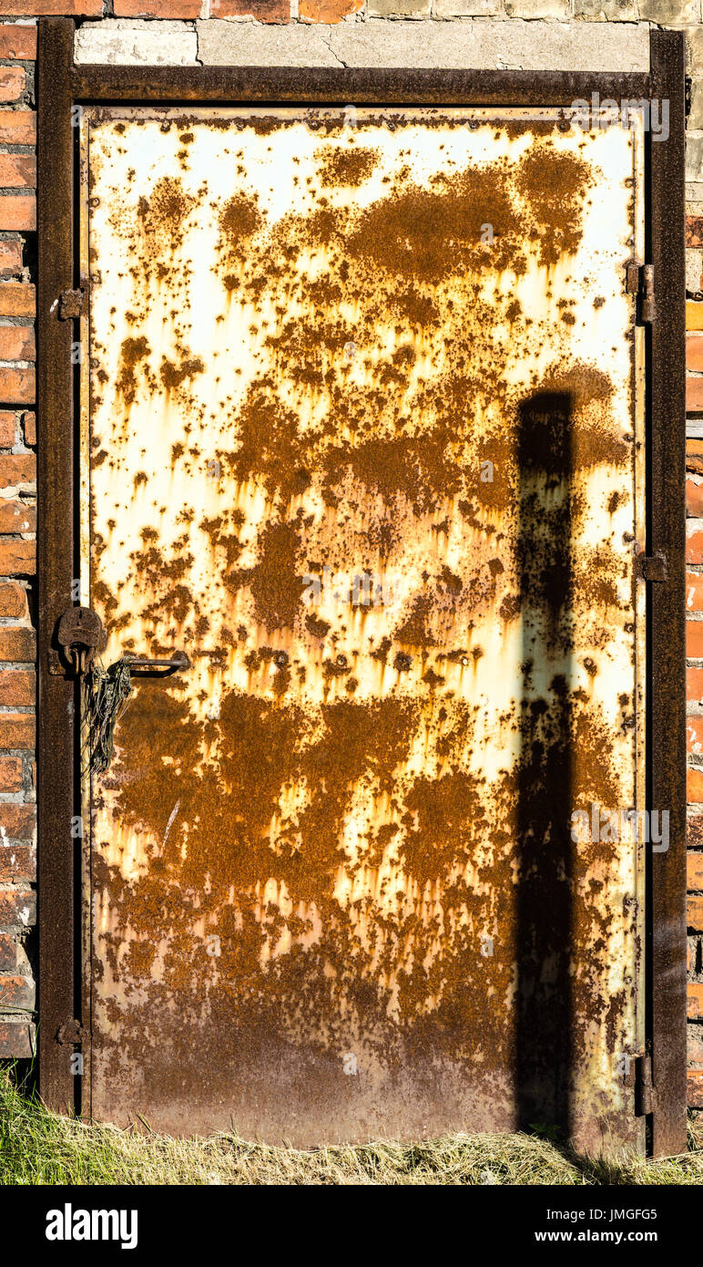 Texture of old cracked paint metal door in brick wall Stock Photo Alamy